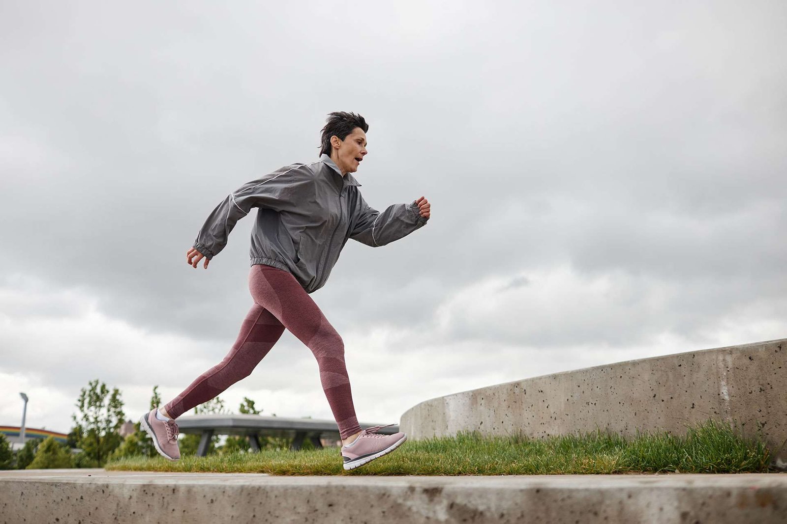 Woman jogging outdoors on cloudy day