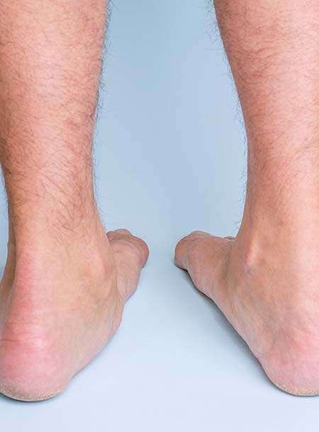 Close-up of bare male legs and feet standing