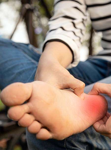 Person massaging another's foot with heart symbol